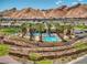 Community pool and recreation area, surrounded by palm trees and beautiful mountain views at 25 Red Creek Bluff St, Henderson, NV 89011