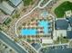 Aerial view of the community pool area, surrounded by palm trees and amenities for residents' enjoyment at 25 Red Creek Bluff St, Henderson, NV 89011