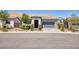 Beautiful single-story home with a well manicured front yard and a two car garage at 25 Red Creek Bluff St, Henderson, NV 89011