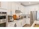 Bright kitchen featuring white cabinetry, stainless steel appliances, and modern fixtures and hardware at 25 Red Creek Bluff St, Henderson, NV 89011