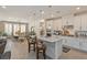 Open-concept kitchen featuring white cabinets, stainless steel appliances, and a spacious center island at 25 Red Creek Bluff St, Henderson, NV 89011