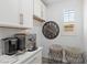 Functional laundry room with sleek appliances, white cabinets, and unique decor at 25 Red Creek Bluff St, Henderson, NV 89011