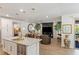 Open concept living space with modern kitchen, stylish seating, and marble fireplace feature wall at 25 Red Creek Bluff St, Henderson, NV 89011