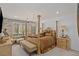Elegant main bedroom with a four-poster bed, chandelier, and a sitting area offering luxurious comfort at 25 Red Creek Bluff St, Henderson, NV 89011