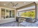 A covered outdoor kitchen featuring bar seating, a built-in grill, and modern ceiling fan at 25 Red Creek Bluff St, Henderson, NV 89011