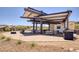 Outdoor kitchen and dining area with modern appliances and ample seating, ideal for entertaining guests at 25 Red Creek Bluff St, Henderson, NV 89011