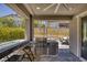 Covered outdoor kitchen features a built-in BBQ, counter seating and stainless steel appliances in a cozy space at 25 Red Creek Bluff St, Henderson, NV 89011
