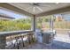 Covered outdoor kitchen with built-in BBQ, bar seating, and stainless steel appliances perfect for entertaining at 25 Red Creek Bluff St, Henderson, NV 89011
