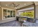 Inviting covered outdoor kitchen with built-in barbecue and bar seating ideal for entertaining guests at 25 Red Creek Bluff St, Henderson, NV 89011