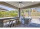 Inviting covered outdoor kitchen with grill, bar seating, and fire feature, perfect for entertaining at 25 Red Creek Bluff St, Henderson, NV 89011