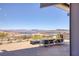 Beautiful patio with a lake and mountain view, fire pit, and comfortable seating for relaxing at 25 Red Creek Bluff St, Henderson, NV 89011