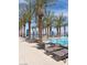 Relaxing community pool featuring palm trees, lounge chairs, and a clear, refreshing swimming area at 25 Red Creek Bluff St, Henderson, NV 89011