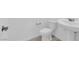 Bright bathroom featuring a toilet, pedestal sink, and modern fixtures at 2536 Vandra St, Las Vegas, NV 89138