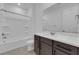 Bathroom featuring a vanity, a large mirror, a bathtub, and a toilet at 2536 Vandra St, Las Vegas, NV 89138