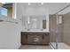 This modern bathroom features a double vanity, tile floors, and a glass shower at 2536 Vandra St, Las Vegas, NV 89138