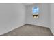 Simple bedroom design featuring carpeted floors, a window with natural light, and neutral walls at 2536 Vandra St, Las Vegas, NV 89138