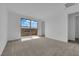 This bedroom has a sliding glass door for outdoor views and neutral decor at 2536 Vandra St, Las Vegas, NV 89138