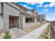 Modern two-story townhome features textured accents, a welcoming entryway, and drought-tolerant landscaping at 2536 Vandra St, Las Vegas, NV 89138