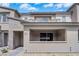 A modern townhome with a covered porch, stone accents, and stylish architecture provides curb appeal at 2536 Vandra St, Las Vegas, NV 89138