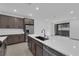 Modern kitchen featuring stainless steel appliances, dark cabinetry, and a large island at 2536 Vandra St, Las Vegas, NV 89138