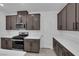 Modern kitchen featuring stainless steel appliances, dark cabinetry, and quartz countertops at 2536 Vandra St, Las Vegas, NV 89138