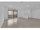 A bright, open living area with tile floors, recessed lighting, and a sliding glass door to the patio at 2536 Vandra St, Las Vegas, NV 89138