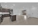 An open-concept living space with a kitchen island, stainless appliances, and sliding door to the patio at 2536 Vandra St, Las Vegas, NV 89138