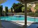 A beautiful backyard pool and spa combo, with a mesh safety fence, is perfect for Gathering fun and relaxation at 2817 Whispering Wind Dr, Las Vegas, NV 89117