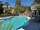 Backyard pool and spa with surrounding landscaping at 2817 Whispering Wind Dr, Las Vegas, NV 89117
