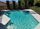 Sparkling in-ground pool features a built-in spa, tiled accents, and convenient access steps at 2817 Whispering Wind Dr, Las Vegas, NV 89117