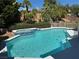 Backyard in-ground pool and spa with surrounding landscaping at 2817 Whispering Wind Dr, Las Vegas, NV 89117