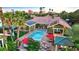 Stunning aerial view of a backyard featuring a sparkling pool, outdoor seating, and lush landscaping with solar panels at 2822 Ashby Ave, Las Vegas, NV 89102