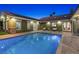 Private backyard oasis with a sparkling pool, seating areas, and lush landscaping at 2822 Ashby Ave, Las Vegas, NV 89102