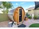 Backyard barrel sauna with pavers and a cozy seating area, blending relaxation and style at 2822 Ashby Ave, Las Vegas, NV 89102