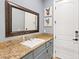 Stylish bathroom featuring granite countertops, grey cabinetry, and unique dog-themed artwork for a modern touch at 2822 Ashby Ave, Las Vegas, NV 89102