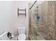 This bathroom features a tiled shower with glass doors and a toilet with a matching tiled floor at 2822 Ashby Ave, Las Vegas, NV 89102