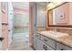 Charming bathroom featuring modern vanity, walk-in shower and wood-look floors at 2822 Ashby Ave, Las Vegas, NV 89102