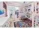 Charming bedroom featuring a colorful rug, walk-in closet, comfortable seating, and stylish decor on light hardwood floors at 2822 Ashby Ave, Las Vegas, NV 89102