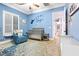 Stylishly decorated bedroom with natural light, a crib and a comfortable blue arm chair at 2822 Ashby Ave, Las Vegas, NV 89102