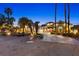 Charming single-story home with stone accents, a well-manicured lawn, mature palms and a circular driveway at 2822 Ashby Ave, Las Vegas, NV 89102