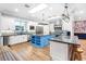 Gourmet kitchen featuring white cabinets, a blue island, stainless steel appliances and hardwood floors at 2822 Ashby Ave, Las Vegas, NV 89102