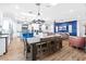 Bright, open-concept kitchen and dining area with modern appliances, a large island, and hardwood floors at 2822 Ashby Ave, Las Vegas, NV 89102