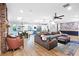 Open-concept living room with a fireplace, hardwood floors, and natural light; adjoins kitchen and dining at 2822 Ashby Ave, Las Vegas, NV 89102