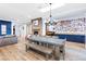 Spacious living room with fireplace and a long table with chairs and bench at 2822 Ashby Ave, Las Vegas, NV 89102