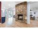 Living room with a stone fireplace and hardwood floors. A blue cabinet can be seen to the left at 2822 Ashby Ave, Las Vegas, NV 89102