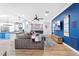 Open concept living room features a kitchen, blue accent wall, and large sectional sofa at 2822 Ashby Ave, Las Vegas, NV 89102