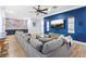 Large living room features a blue accent wall, couch and colorful decor at 2822 Ashby Ave, Las Vegas, NV 89102