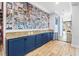 Living space featuring hardwood floors, a built in blue cabinet, and a decorative picture wall at 2822 Ashby Ave, Las Vegas, NV 89102