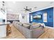 Relaxing living space with hardwood floors, a blue accent wall with a TV, and an extra long couch at 2822 Ashby Ave, Las Vegas, NV 89102