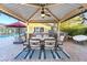 Backyard outdoor kitchen with dining table, ceiling fan, swimming pool and grill at 2822 Ashby Ave, Las Vegas, NV 89102